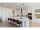 Spacious kitchen boasts white cabinets, stainless appliances, a large island with seating, and modern fixtures at 2606 E Virginia Cir, Mesa, AZ 85213
