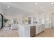 Open-concept kitchen with a large island, stainless steel appliances, and seamless flow to the living area at 2606 E Virginia Cir, Mesa, AZ 85213