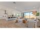 Open-concept living room with seamless access to kitchen, dining, and outdoor areas via sliding glass door at 2606 E Virginia Cir, Mesa, AZ 85213