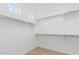 Spacious walk-in closet with built-in shelving, offering ample storage space for clothing at 2606 E Virginia Cir, Mesa, AZ 85213