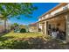 Backyard with a large grassy area, covered patio and a beautiful pool at 26066 N 72Nd Ave, Peoria, AZ 85383