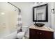 Bathroom featuring a vessel sink, framed mirror, and a tub with shower at 26066 N 72Nd Ave, Peoria, AZ 85383