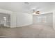Spacious bedroom featuring plush carpeting, a ceiling fan, and lots of natural light at 26066 N 72Nd Ave, Peoria, AZ 85383