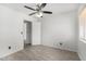 Bedroom with ceiling fan, wood tile floors, and a window with blinds at 26066 N 72Nd Ave, Peoria, AZ 85383