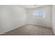 Bedroom features neutral carpeting, a window, and white walls at 26066 N 72Nd Ave, Peoria, AZ 85383