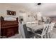 Elegant dining area with an antique organ, rustic table, and statement light fixture at 26066 N 72Nd Ave, Peoria, AZ 85383