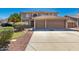 Inviting two-story home with a spacious driveway and a two-car garage, complemented by desert-style landscaping at 26066 N 72Nd Ave, Peoria, AZ 85383