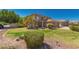 Charming two-story home featuring a well-maintained lawn and desert landscaping with mature trees and shrubs at 26066 N 72Nd Ave, Peoria, AZ 85383