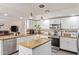 Updated kitchen boasts granite countertops, stainless steel appliances, and white cabinetry at 26066 N 72Nd Ave, Peoria, AZ 85383