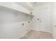 Laundry room with tile flooring, white cabinets, and washer dryer hookups at 26066 N 72Nd Ave, Peoria, AZ 85383