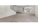 Comfortable living room with carpet, a large window, and staircase access at 26066 N 72Nd Ave, Peoria, AZ 85383