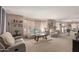 Cozy living room with neutral decor, carpet, and large windows, open to the dining area at 26066 N 72Nd Ave, Peoria, AZ 85383