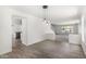 Bright, open-concept living area with modern lighting and adjoining rooms at 26066 N 72Nd Ave, Peoria, AZ 85383