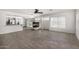 Open-concept living space featuring a fireplace, kitchen, dining, and living areas at 26066 N 72Nd Ave, Peoria, AZ 85383