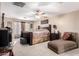 Comfortable bedroom with a ceiling fan, neutral walls, and an upholstered chaise lounge at 26066 N 72Nd Ave, Peoria, AZ 85383