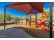 Brightly colored playground with sunshade, slides and climbing equipment for community children at 26066 N 72Nd Ave, Peoria, AZ 85383