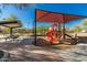 Community playground featuring a sunshade, climbing structure, slide, and covered picnic area at 26066 N 72Nd Ave, Peoria, AZ 85383