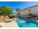 Backyard pool with a waterfall feature surrounded by a concrete deck at 26066 N 72Nd Ave, Peoria, AZ 85383