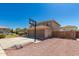 Backyard featuring a basketball hoop, with a two-car garage, complemented by desert-style landscaping at 26066 N 72Nd Ave, Peoria, AZ 85383