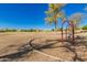 Red-framed swing set in a community park with neighborhood homes in the background at 26066 N 72Nd Ave, Peoria, AZ 85383