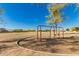 Community swing set for outdoor play and recreation in a shared green space at 26066 N 72Nd Ave, Peoria, AZ 85383