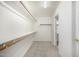 Walk-in closet features wooden clothing racks and shelving at 26066 N 72Nd Ave, Peoria, AZ 85383
