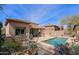 Stunning backyard oasis with sparkling pool, desert landscaping and outdoor seating area at 32835 N 70Th St, Scottsdale, AZ 85266