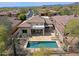 Aerial view of the backyard featuring a private pool with a large stone patio and desert landscaping at 32835 N 70Th St, Scottsdale, AZ 85266