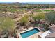 Aerial view of a backyard featuring a pool with a stone patio and distant views of the golf course at 32835 N 70Th St, Scottsdale, AZ 85266