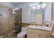 Bathroom featuring granite countertop vanity and tiled walk-in shower with glass door at 32835 N 70Th St, Scottsdale, AZ 85266