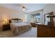 Cozy bedroom with neutral tones, ceiling fan, and access to outdoor patio at 32835 N 70Th St, Scottsdale, AZ 85266