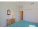 Bedroom with light wood dresser and a closet door, with blue bedspread at 32835 N 70Th St, Scottsdale, AZ 85266