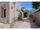 Exterior view of a home with a walkway and desert landscaping, including cacti and decorative gravel at 32835 N 70Th St, Scottsdale, AZ 85266