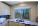 Kitchen window showing a double sink and a view of the desert landscape at 32835 N 70Th St, Scottsdale, AZ 85266