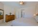 Large bedroom featuring a dresser, ceiling fan, and doorway to the ensuite bath at 32835 N 70Th St, Scottsdale, AZ 85266