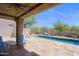 Relaxing patio with travertine flooring, outdoor lounge furniture, and a private pool at 32835 N 70Th St, Scottsdale, AZ 85266