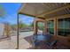 Inviting covered patio has outdoor seating and views of the pool and desert landscape at 32835 N 70Th St, Scottsdale, AZ 85266
