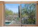 Exterior view from a kitchen window overlooking lush desert landscaping at 32835 N 70Th St, Scottsdale, AZ 85266