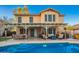 Lovely backyard features a shimmering pool, covered patio, outdoor kitchen, and lush landscaping at 3473 E Wyatt Way, Gilbert, AZ 85297