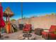 Cozy backyard setting with gravel, a fire pit surrounded by seating, and privacy walls at 3473 E Wyatt Way, Gilbert, AZ 85297