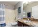 Well-lit bathroom featuring a shower-tub combo and vanity with granite countertops at 3473 E Wyatt Way, Gilbert, AZ 85297