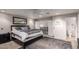Bright bedroom featuring a comfortable bed, dark wood furnishings and a gray rug, complete with ceiling fan and access to bath at 3473 E Wyatt Way, Gilbert, AZ 85297