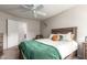 Cozy bedroom with a ceiling fan, wooden bed frame, and neutral color palette at 3473 E Wyatt Way, Gilbert, AZ 85297