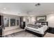 Relaxing bedroom featuring a comfortable bed, dark wood furnishings and a gray rug; sunlight floods the room through a large window at 3473 E Wyatt Way, Gilbert, AZ 85297