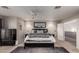 Spacious bedroom featuring a comfortable bed, dark wood furnishings and a gray rug, complete with ceiling fan and plenty of light at 3473 E Wyatt Way, Gilbert, AZ 85297
