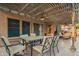 Inviting covered patio features a tile table, comfortable seating, and a charming pergola adorned with string lights at 3473 E Wyatt Way, Gilbert, AZ 85297