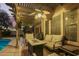 Relaxing covered patio offers a cozy seating area with a fire pit, perfect for outdoor entertaining at 3473 E Wyatt Way, Gilbert, AZ 85297