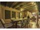 Charming covered patio features a dining table, comfortable seating, and a warm, inviting atmosphere at 3473 E Wyatt Way, Gilbert, AZ 85297