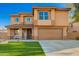 Two-story home showcasing an attractive facade, manicured lawn, and a welcoming covered porch at 3473 E Wyatt Way, Gilbert, AZ 85297