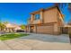 Two-story home showcasing an attractive facade, manicured lawn, and a welcoming covered porch at 3473 E Wyatt Way, Gilbert, AZ 85297